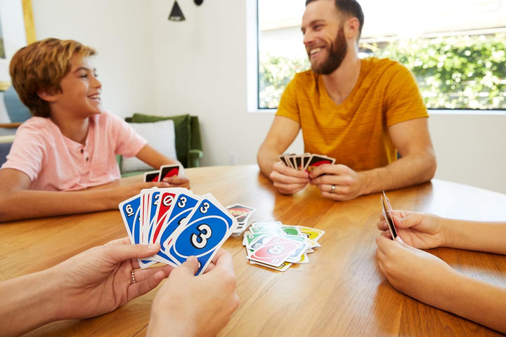 Family enjoying a game of UNO with action and Wild Cards